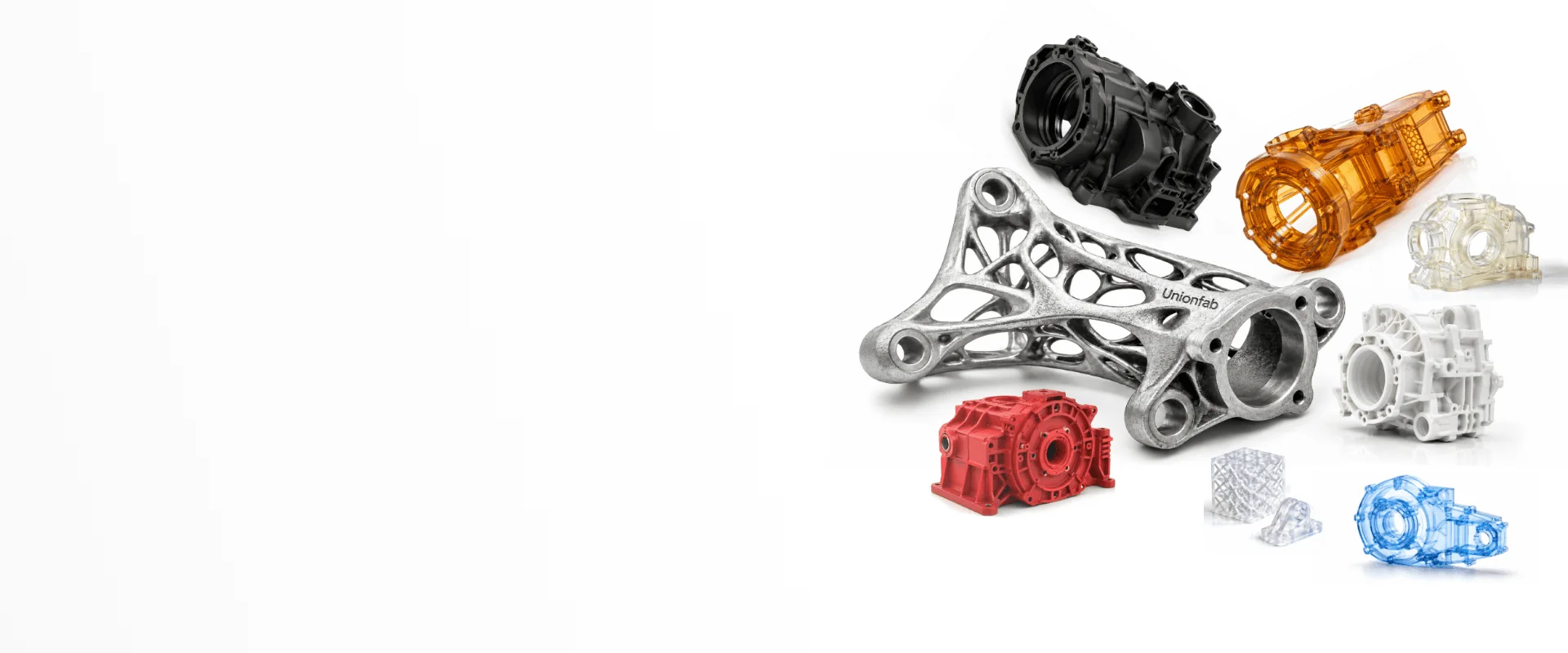 Various 3D printed and CNC machined metal, resin, and plastic parts for industrial manufacturing.