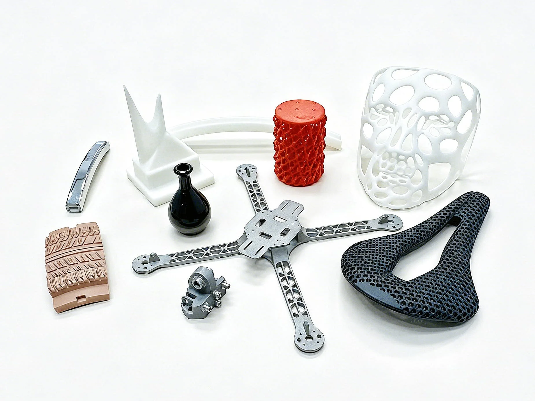 Various 3D printed and CNC machined metal, resin, and plastic parts for industrial manufacturing.